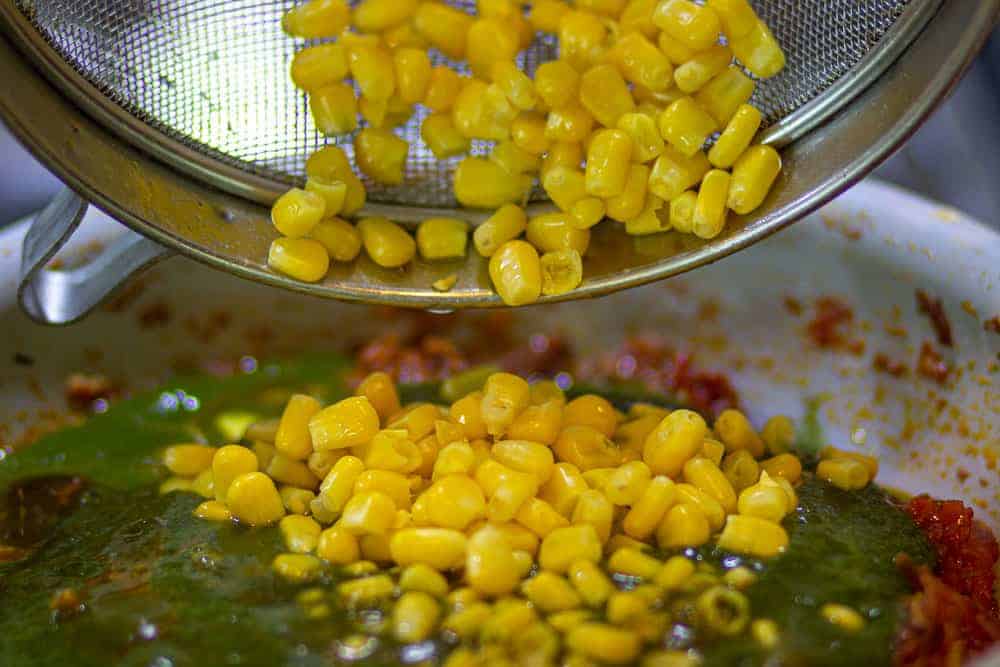 add boiled corns in the pan