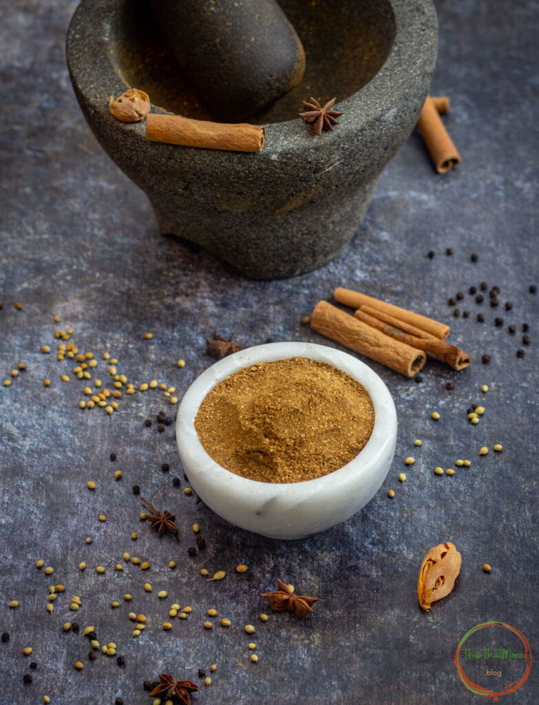 Grounded garam masala in a white bowl.