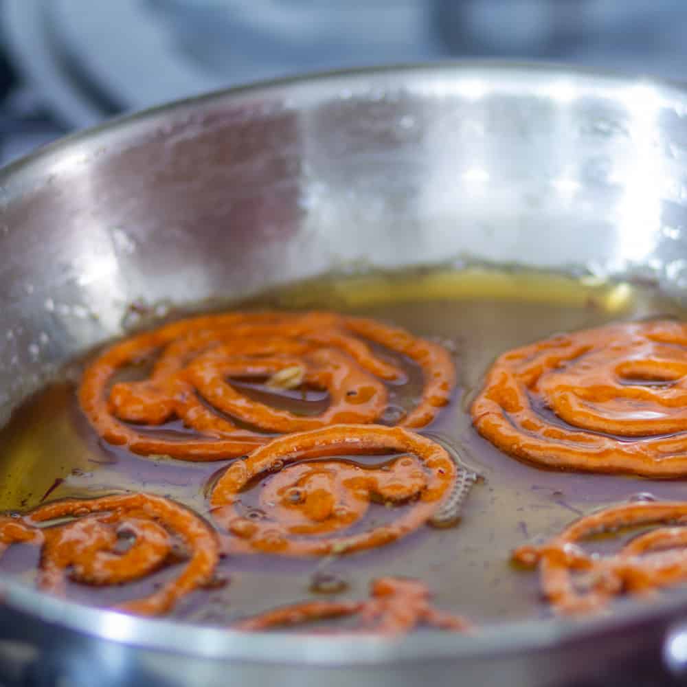 place prepared jalebi in the sugar syrup for few seconds and serve