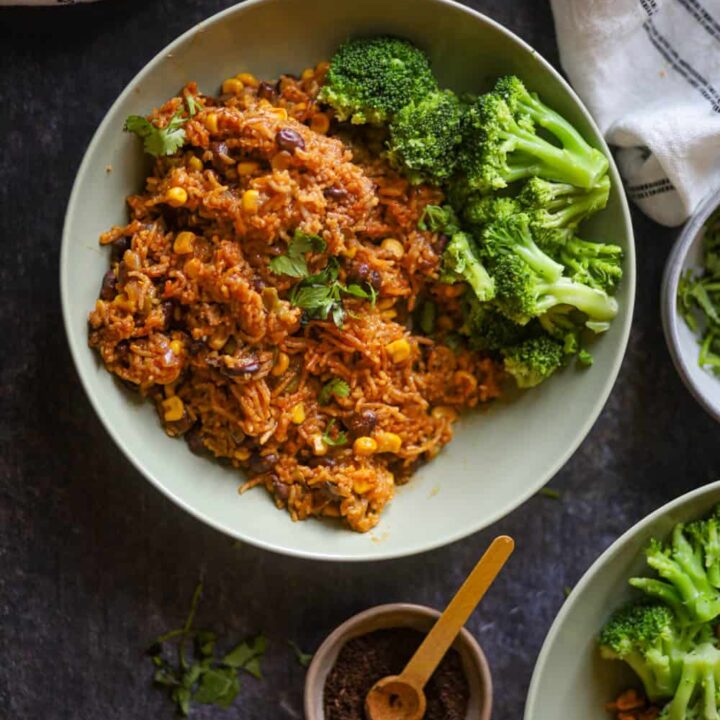 enchilada rice served with brocolli in white bowl