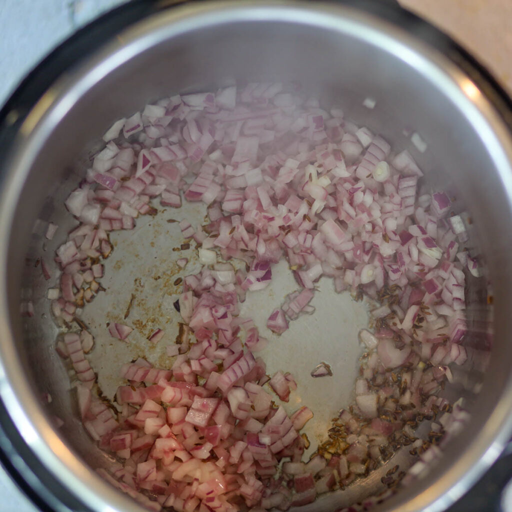 In oil add cumin seeds & onions