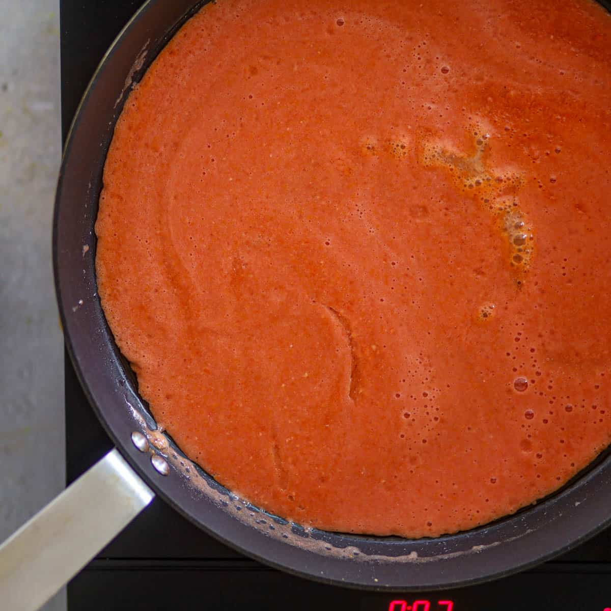 add pureed tomatoes in a pan.