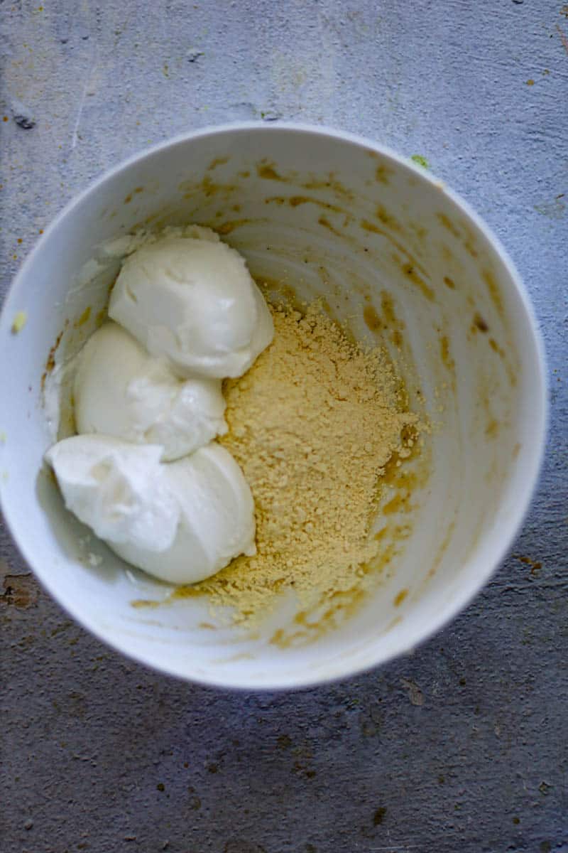 add gram flour, and yogurt in a bowl. 