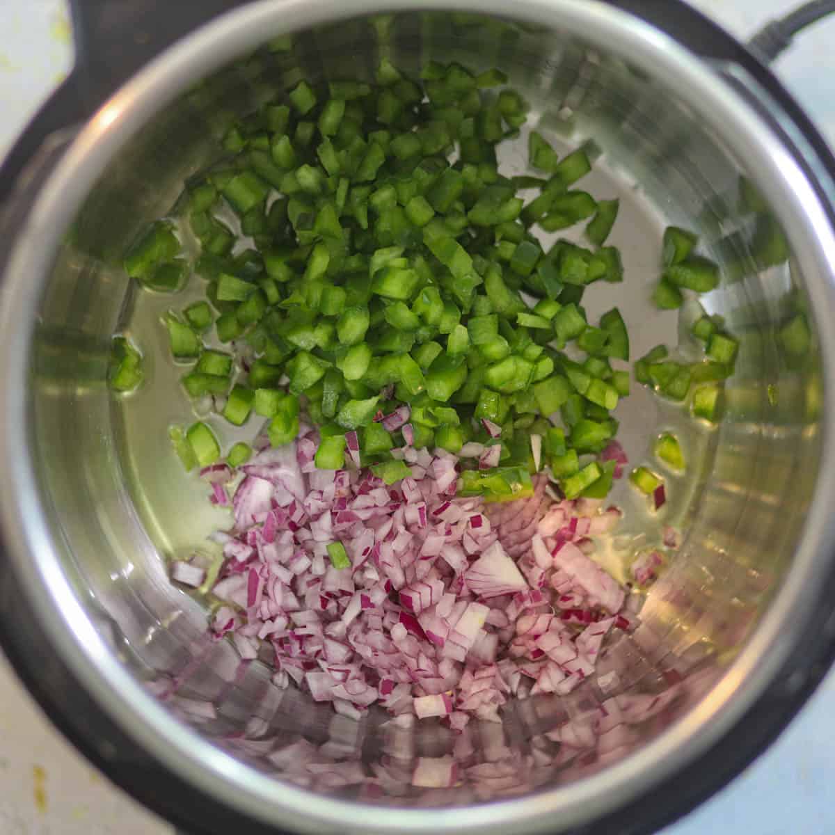 add onion and bell peppers in the Instant pot.