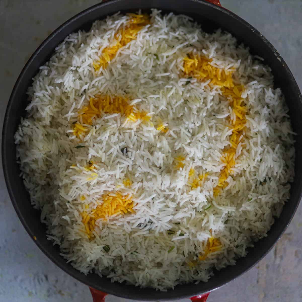Top it with partially cook rice and top it with saffron milk and rose water.
