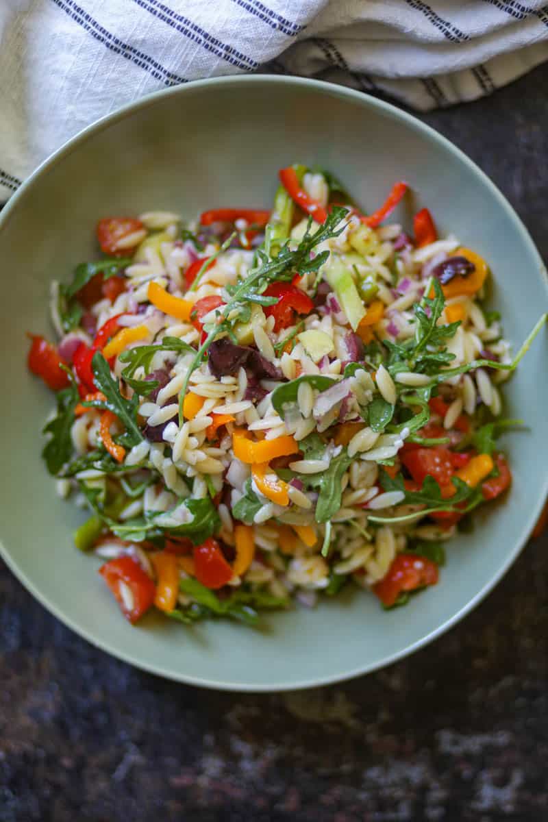 Lemon Orzo Salad served in a green bowl.