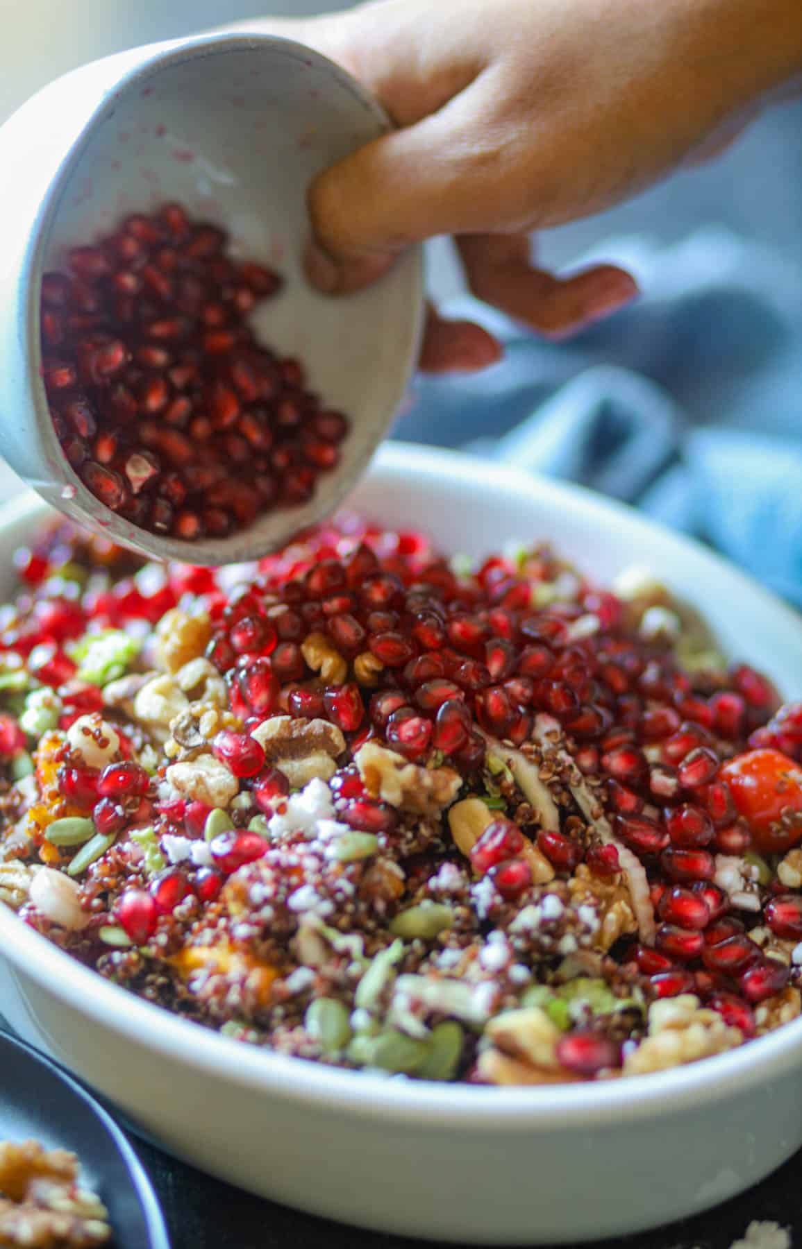 Pomegranate seeds are added to pumpkin quinoa salad. 
